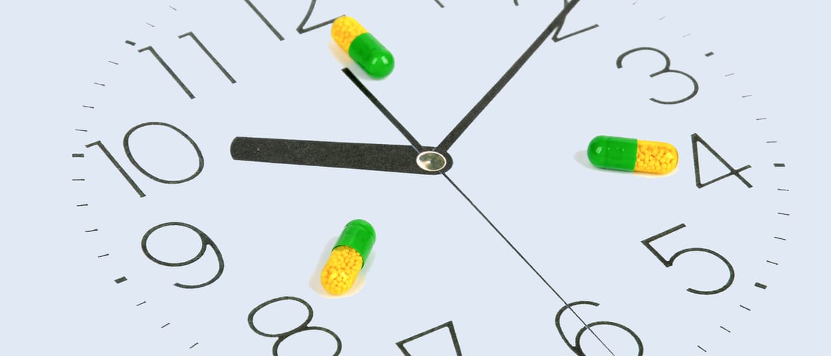 Pharmacist organizing a patient’s synchronized monthly prescriptions